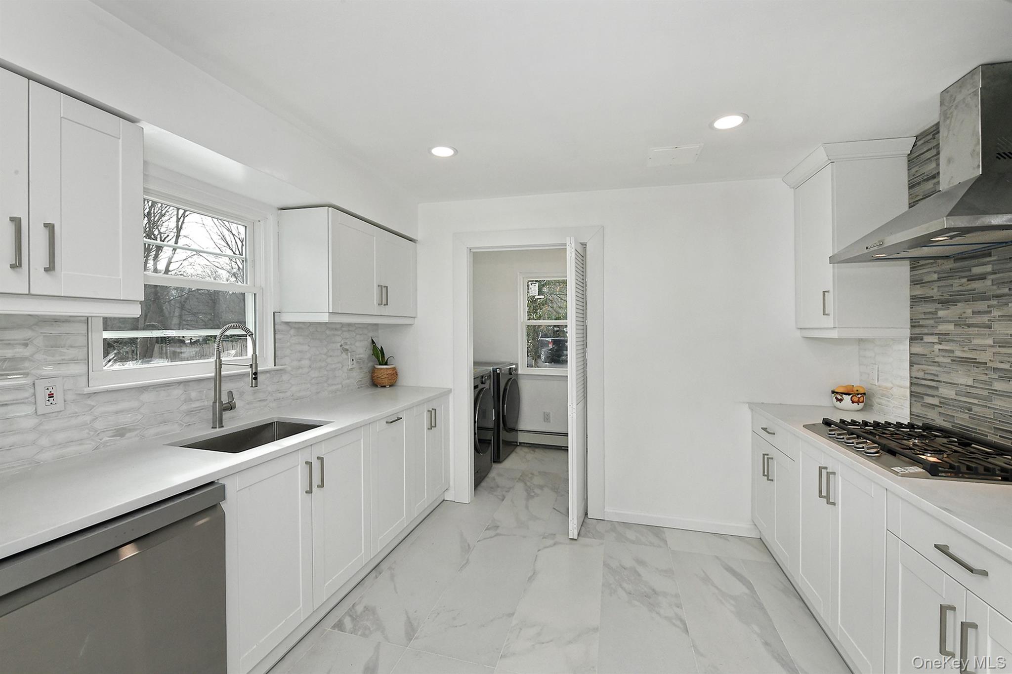 34 Warner Road Huntington, NY 11743 - Photo 13 of 39 a kitchen with a sink stove and cabinets