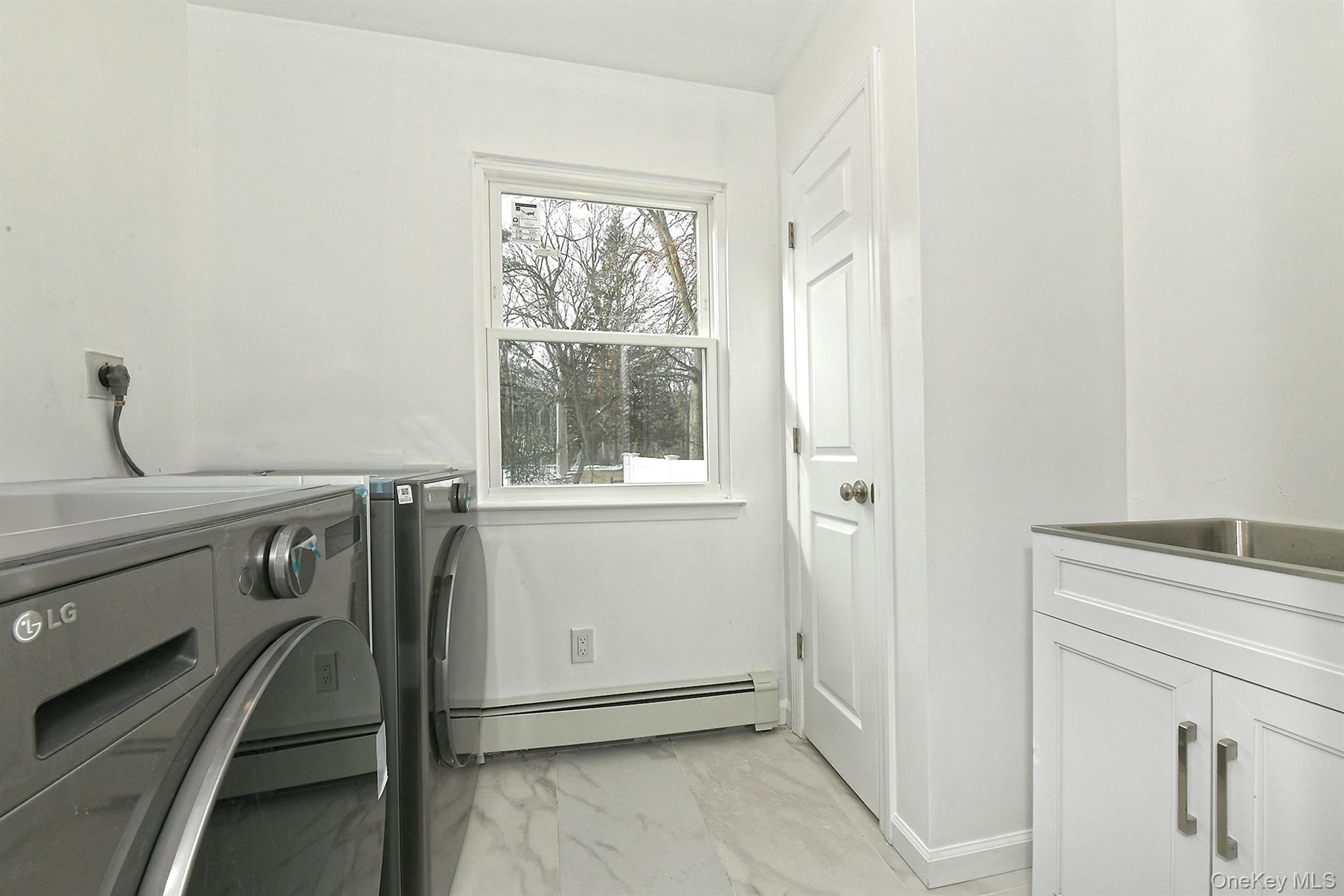 34 Warner Road Huntington, NY 11743 - Photo 14 of 39 a utility room with dryer and washer