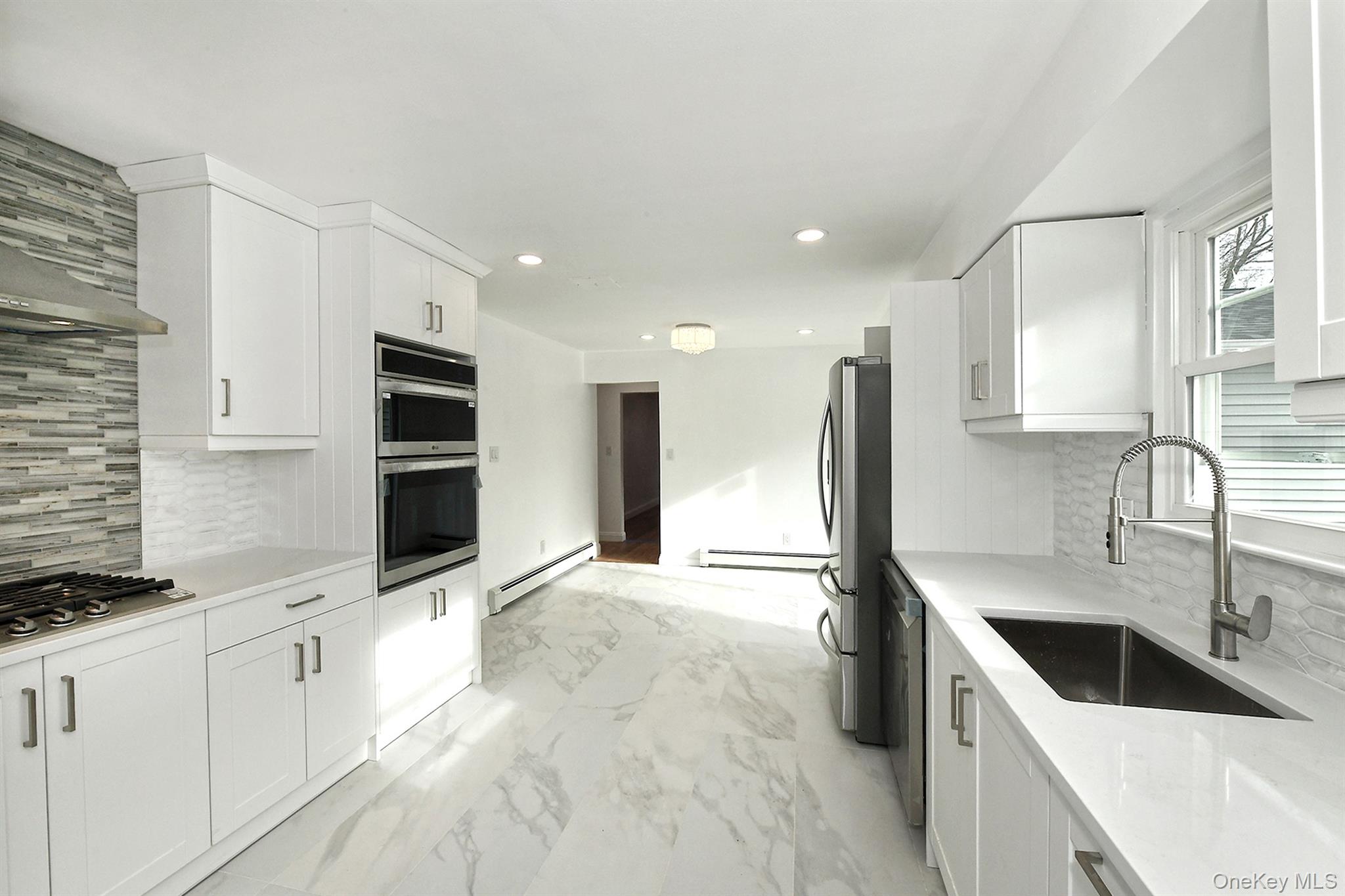 34 Warner Road Huntington, NY 11743 - Photo 15 of 39 a kitchen with stainless steel appliances granite countertop a sink a stove and a refrigerator