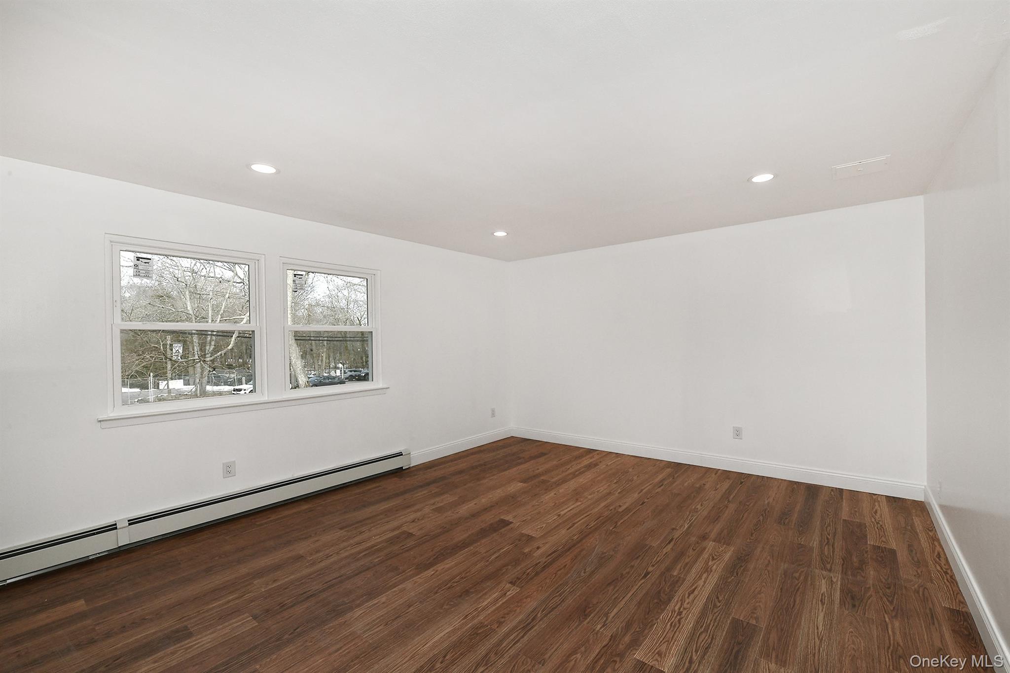 34 Warner Road Huntington, NY 11743 - Photo 20 of 39 an empty room with wooden floor and windows
