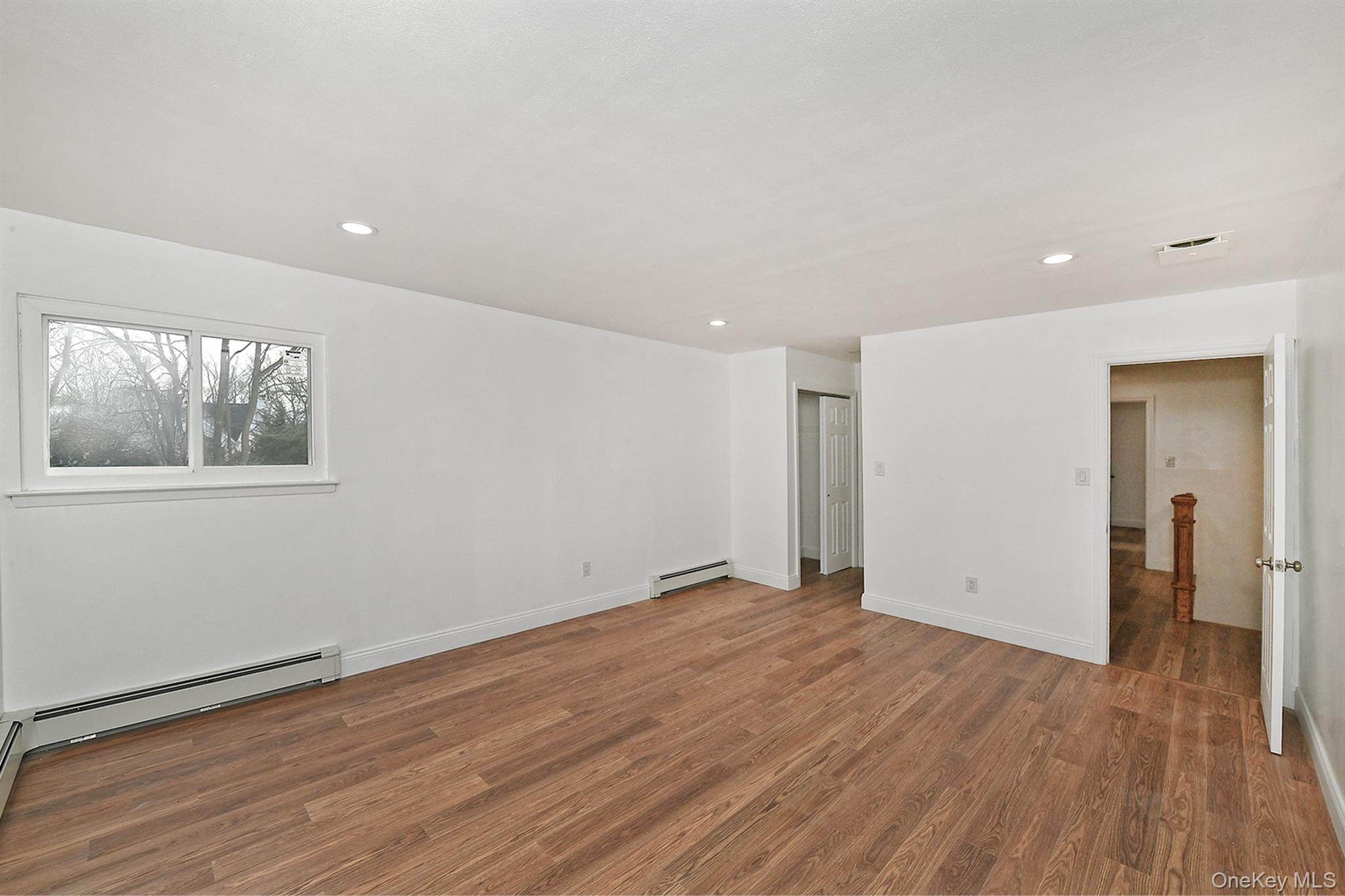 34 Warner Road Huntington, NY 11743 - Photo 22 of 39 a view of an empty room with wooden floor and a window