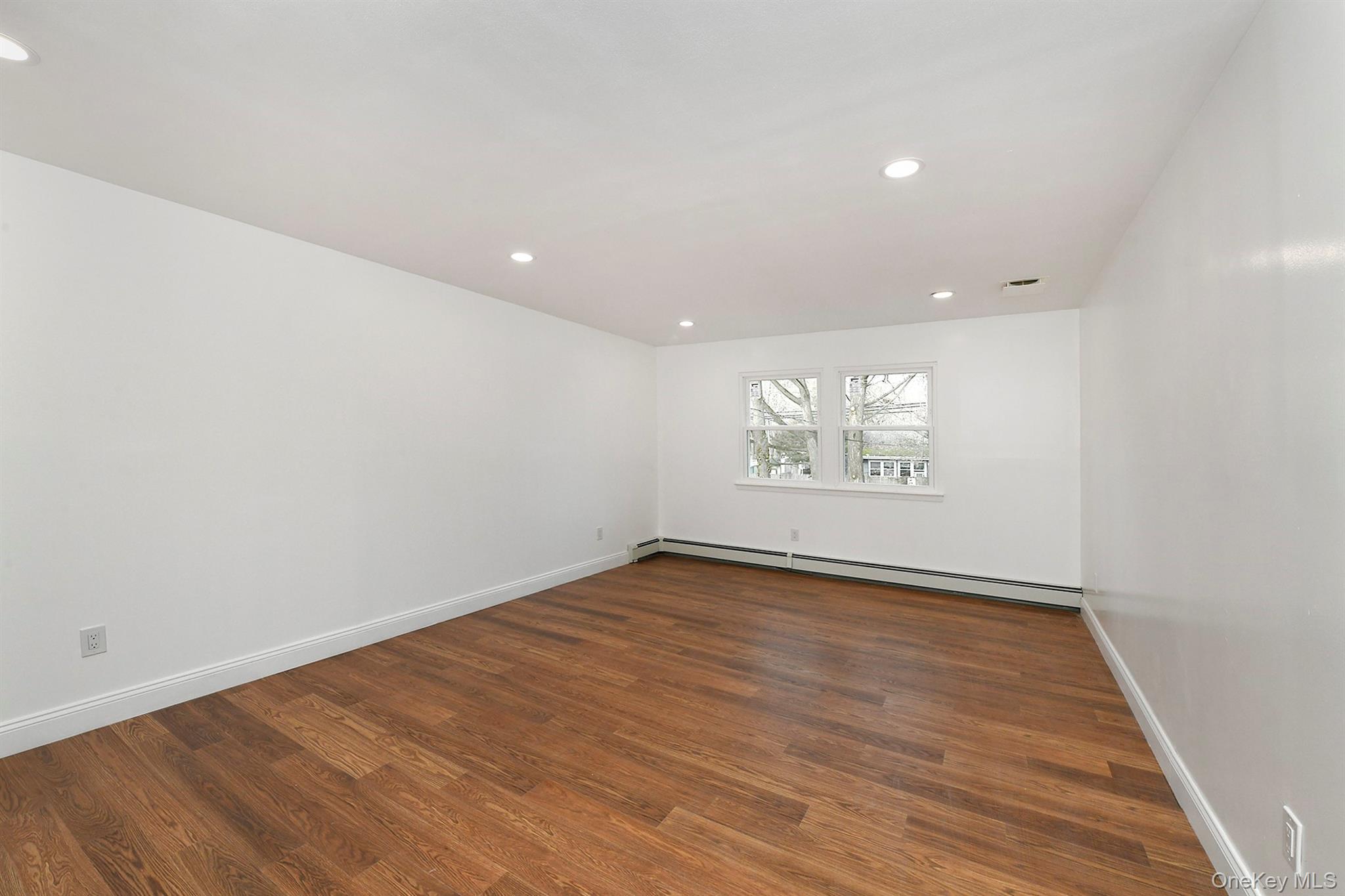 34 Warner Road Huntington, NY 11743 - Photo 25 of 39 an empty room with wooden floor and windows