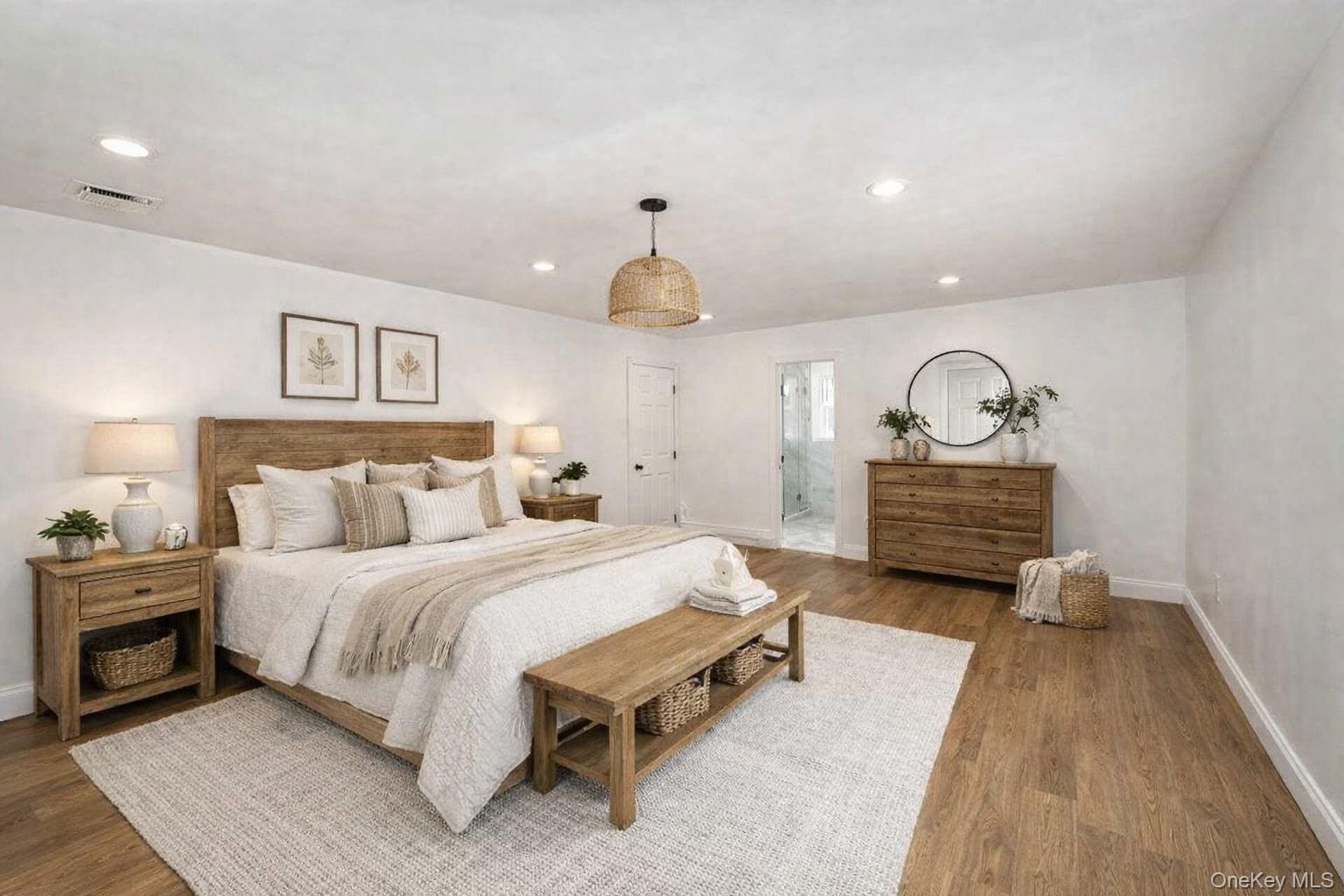 34 Warner Road Huntington, NY 11743 - Photo 27 of 39 a spacious bedroom with a bed a rug and a chandelier