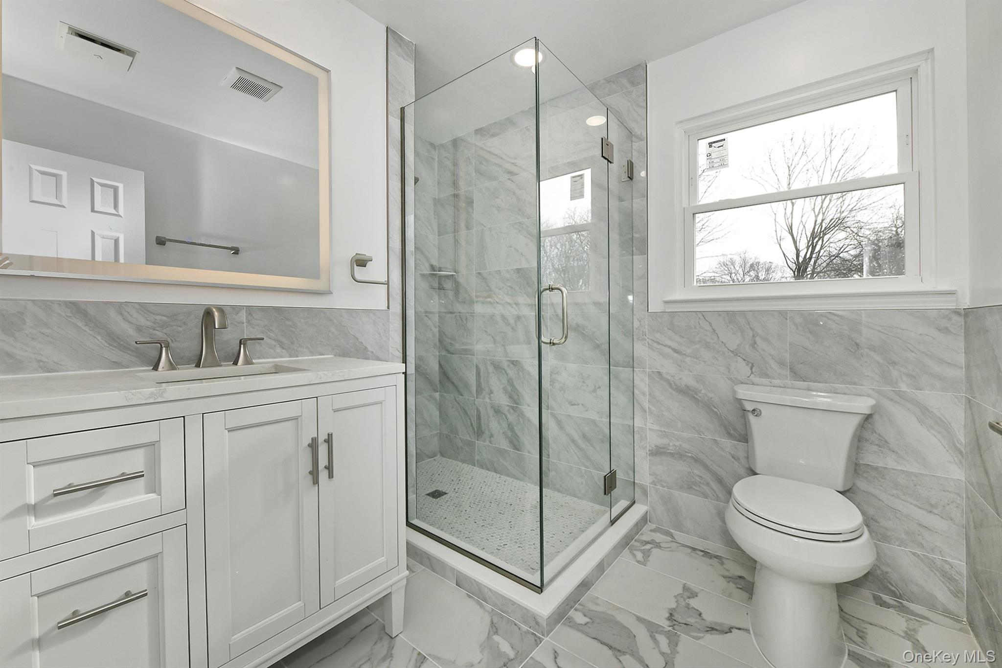 34 Warner Road Huntington, NY 11743 - Photo 28 of 39 a bathroom with a shower sink vanity mirror and toilet