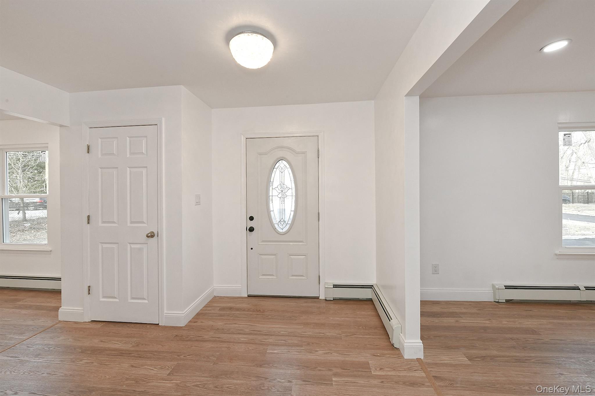 34 Warner Road Huntington, NY 11743 - Photo 3 of 39 an empty room with wooden floor cabinet and windows