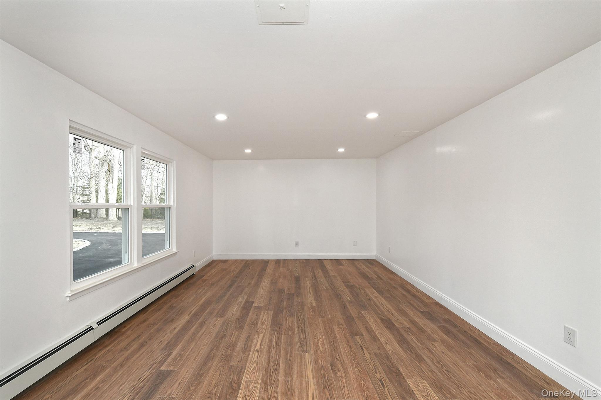 34 Warner Road Huntington, NY 11743 - Photo 5 of 39 a view of empty room with wooden floor and fan