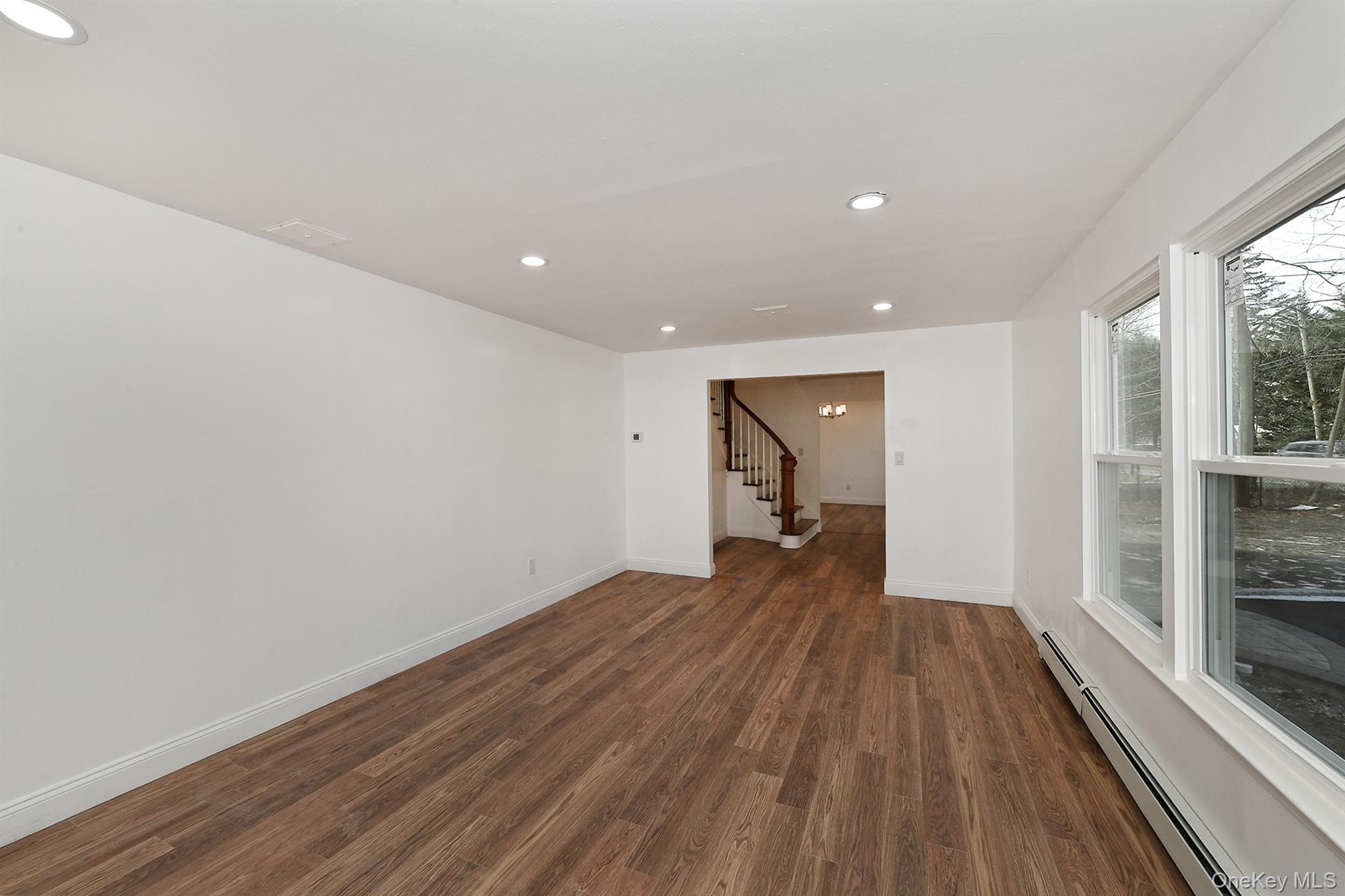 34 Warner Road Huntington, NY 11743 - Photo 7 of 39 a view of an empty room with wooden floor and a window