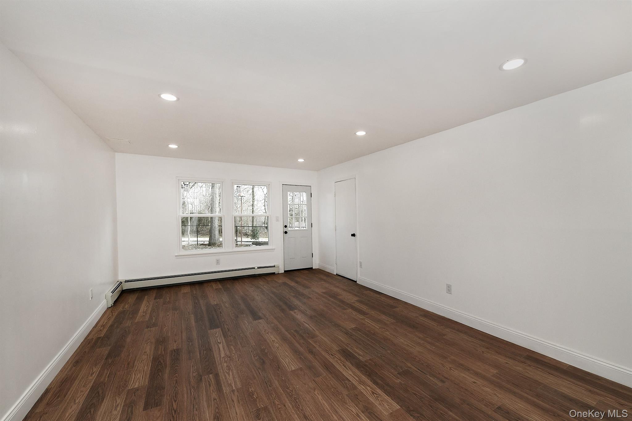 34 Warner Road Huntington, NY 11743 - Photo 9 of 39 a view of an empty room with wooden floor and a window