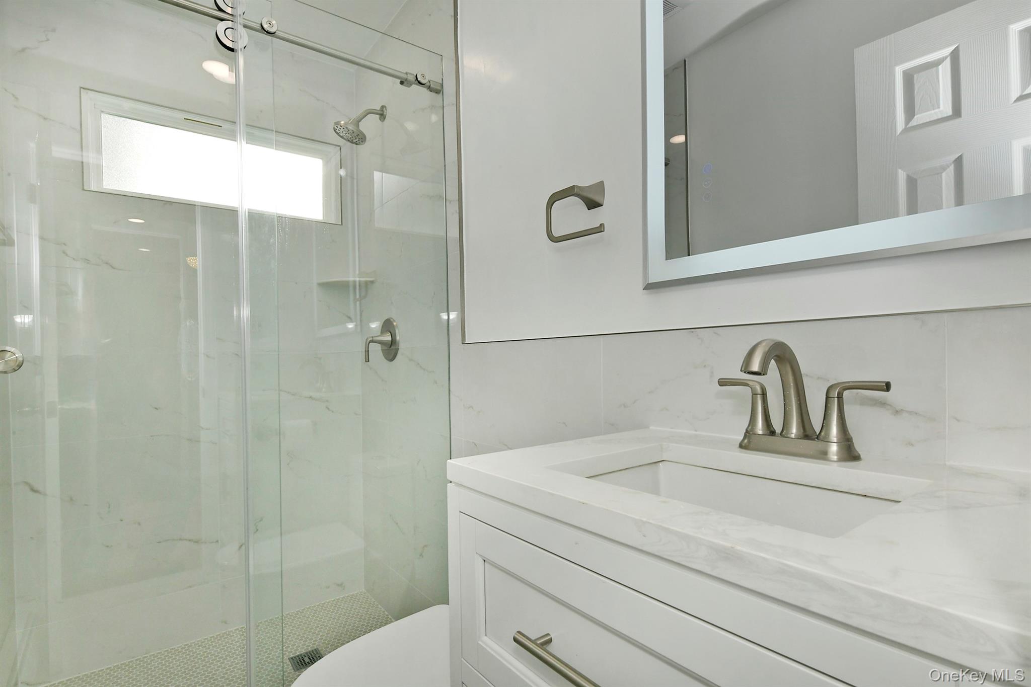 34 Warner Road Huntington, NY 11743 - Photo 10 of 39 a bathroom with a sink and a mirror