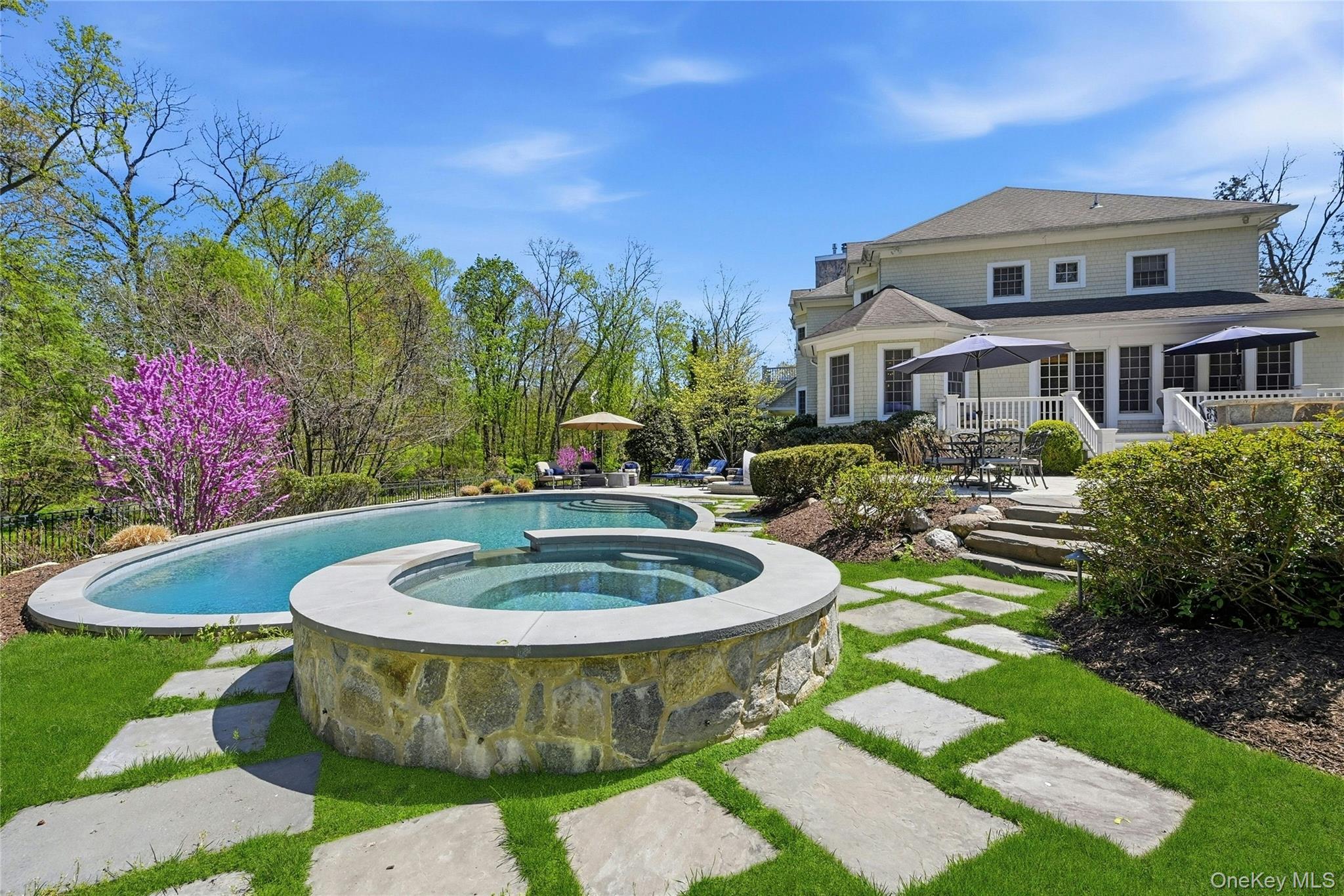 5 Mill Road Lloyd Harbor, NY 11743 - Photo 42 of 49 a view of a white house with a swimming pool and outdoor seating