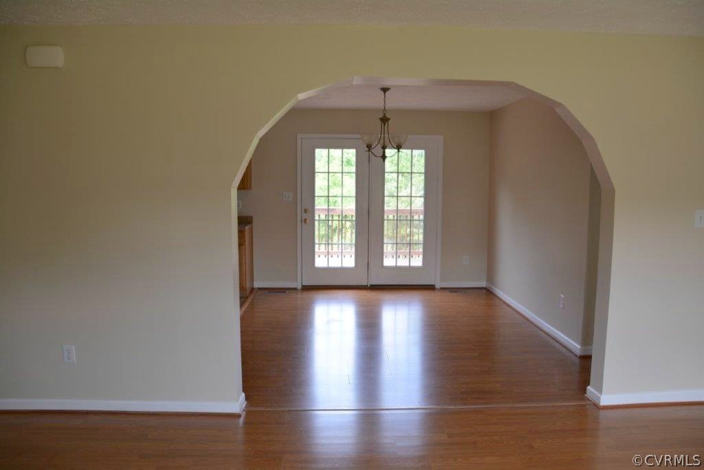 2372 Stage Coach Road Farmville, VA 23901 - Photo 3 of 13 an empty room with wooden floor and windows