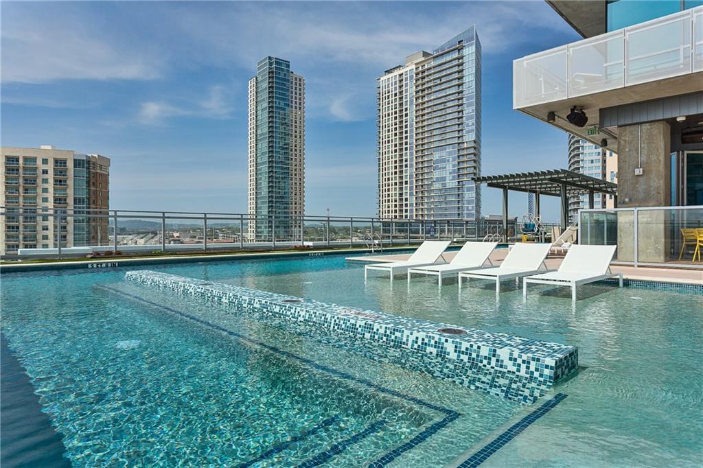 222 West Avenue, Unit 2207 Austin, TX 78701 - Photo 21 of 30 Rooftop swimming pool featuring a tiled spa area, clear water, and a surrounding deck