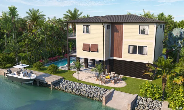 a view of a house with patio furniture and garden