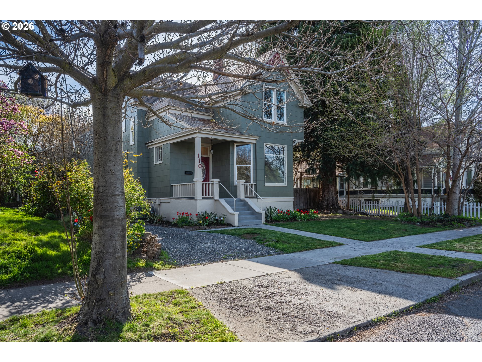 110 West 8th Street The Dalles, OR 97058 - Photo 2 of 43 a front view of a house with a garden