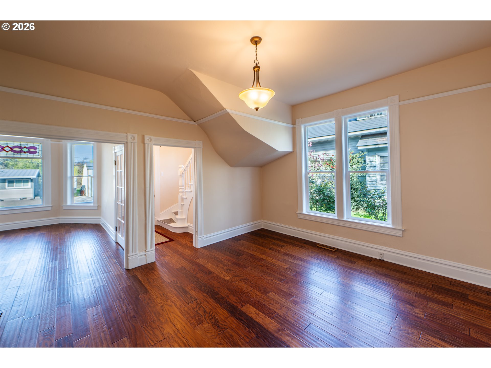 110 West 8th Street The Dalles, OR 97058 - Photo 8 of 43 a view of an empty room with wooden floor and a window