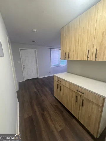 a view of kitchen with wooden floor