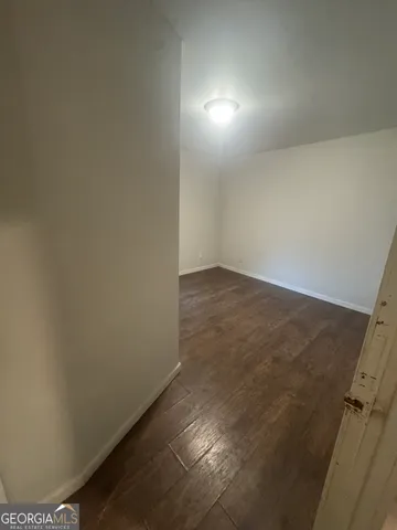 an empty room with wooden floor