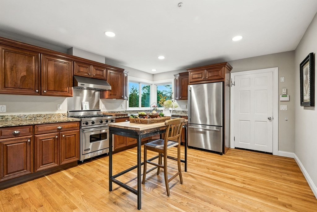 52 Wenham Road Topsfield, MA 01983 - Photo 14 of 42 a kitchen with stainless steel appliances granite countertop a refrigerator stove microwave and sink