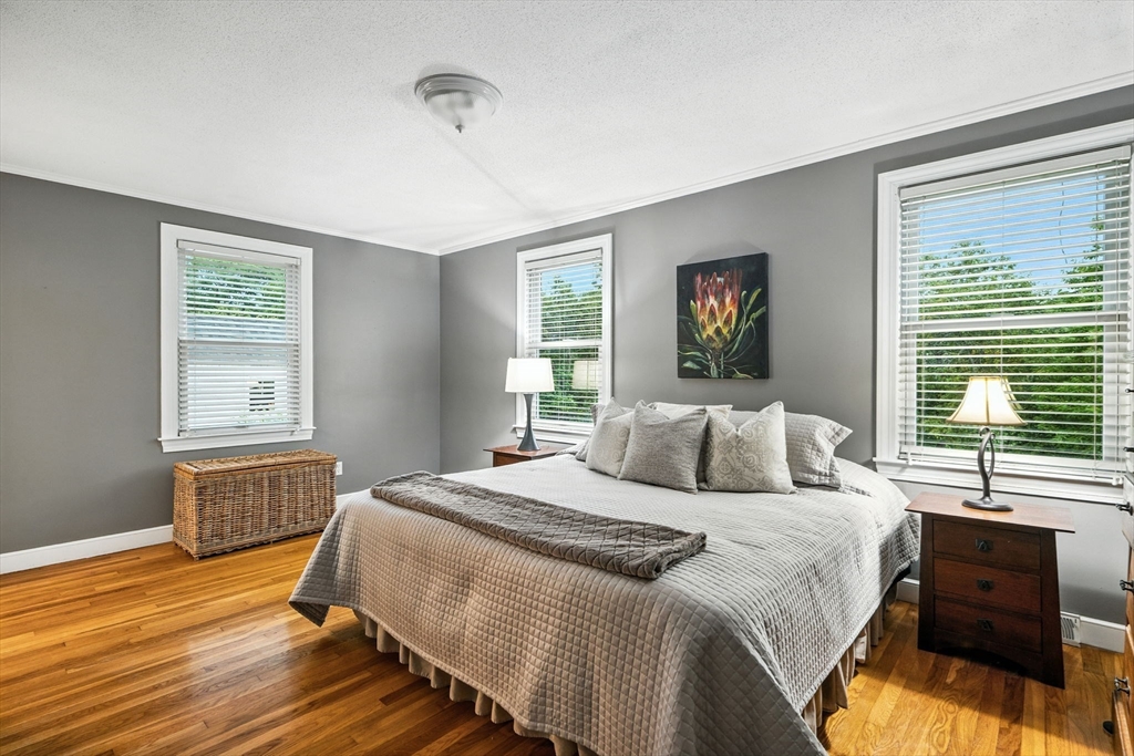 52 Wenham Road Topsfield, MA 01983 - Photo 19 of 42 a bedroom with a bed and wooden floor