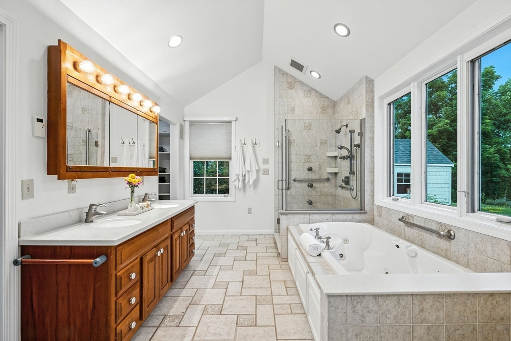 52 Wenham Road Topsfield, MA 01983 - Photo 21 of 42 a spacious bathroom with a bathtub sink and mirror