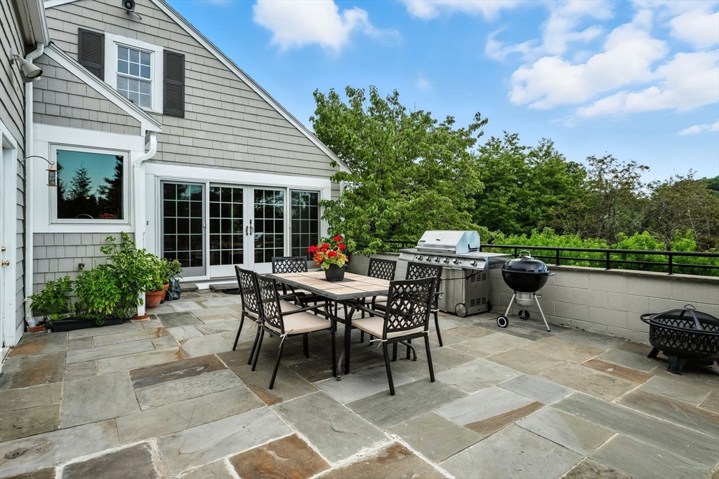 52 Wenham Road Topsfield, MA 01983 - Photo 9 of 42 a view of a patio with table and chairs and potted plants