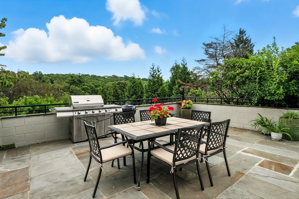 52 Wenham Road Topsfield, MA 01983 - Photo 10 of 42 a view of a terrace with a table and chairs