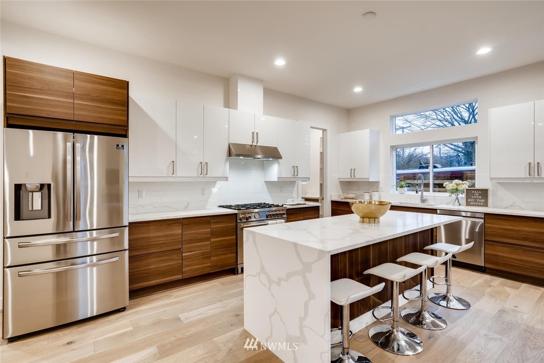 5603 42nd Avenue Southwest Seattle, WA 98136 - Photo 11 of 40 a kitchen with a sink stainless steel appliances and cabinets