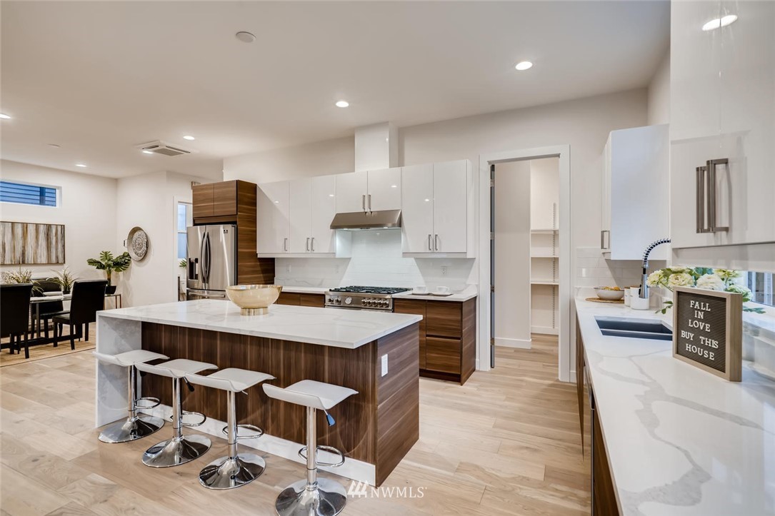 5603 42nd Avenue Southwest Seattle, WA 98136 - Photo 13 of 40 a large kitchen with a table and chairs in it