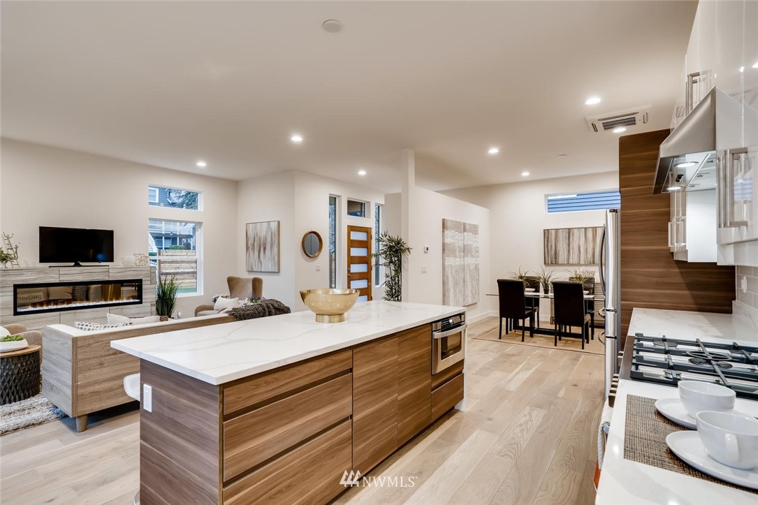5603 42nd Avenue Southwest Seattle, WA 98136 - Photo 15 of 40 a large kitchen with stainless steel appliances granite countertop a large center island and a stove
