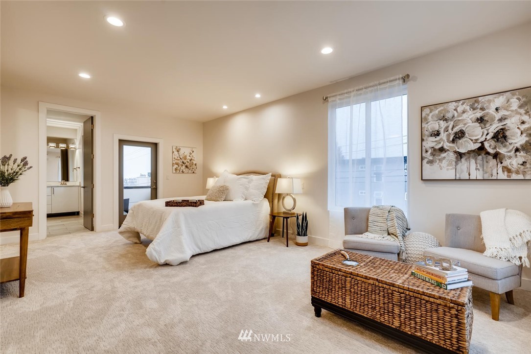 5603 42nd Avenue Southwest Seattle, WA 98136 - Photo 21 of 40 a spacious bedroom with a bed and glass walk in closet