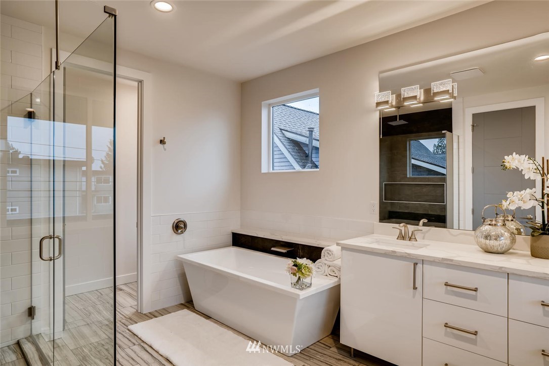 5603 42nd Avenue Southwest Seattle, WA 98136 - Photo 25 of 40 a bathroom with a tub sink and mirror