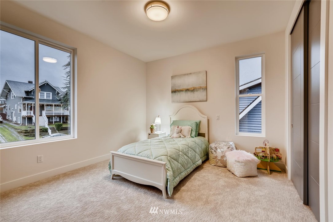 5603 42nd Avenue Southwest Seattle, WA 98136 - Photo 26 of 40 a bedroom with a bed and a window
