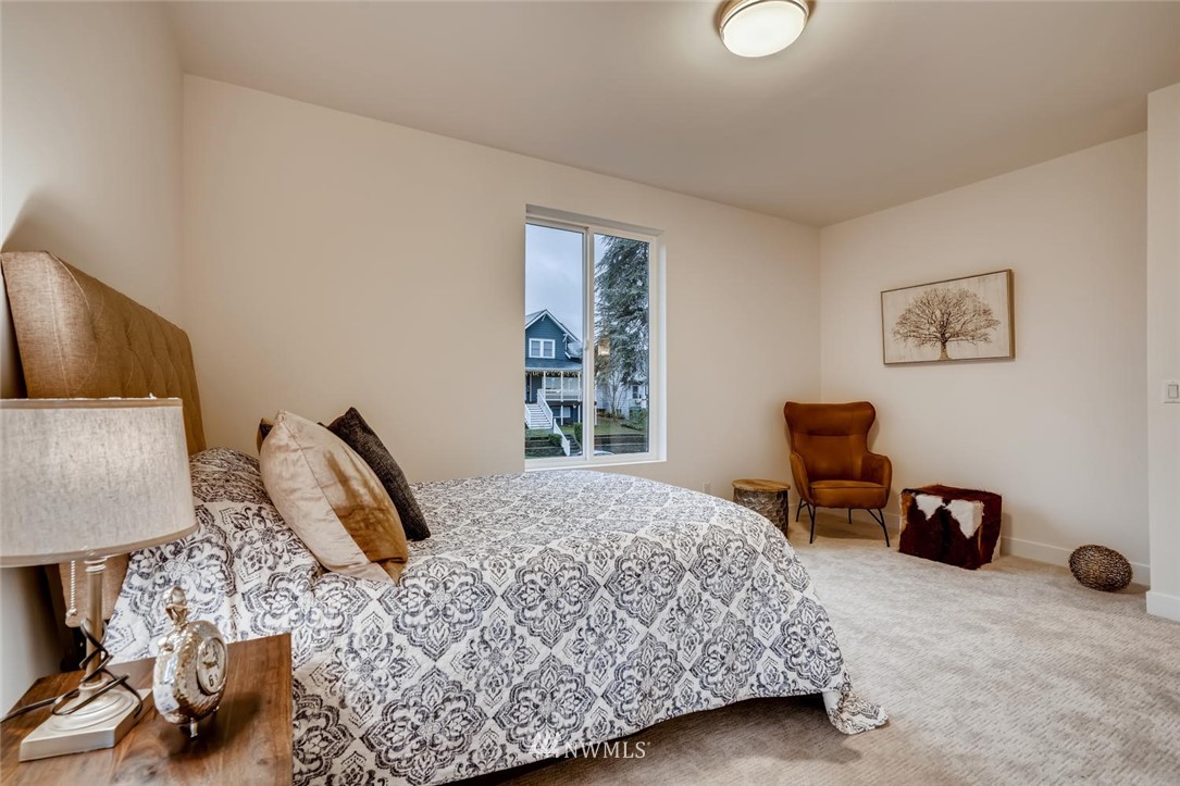 5603 42nd Avenue Southwest Seattle, WA 98136 - Photo 28 of 40 a bedroom with a bed a chair and next to a window