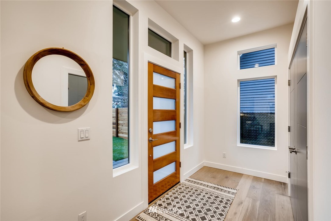 5603 42nd Avenue Southwest Seattle, WA 98136 - Photo 6 of 40 a view of a bedroom with wooden floor and a window