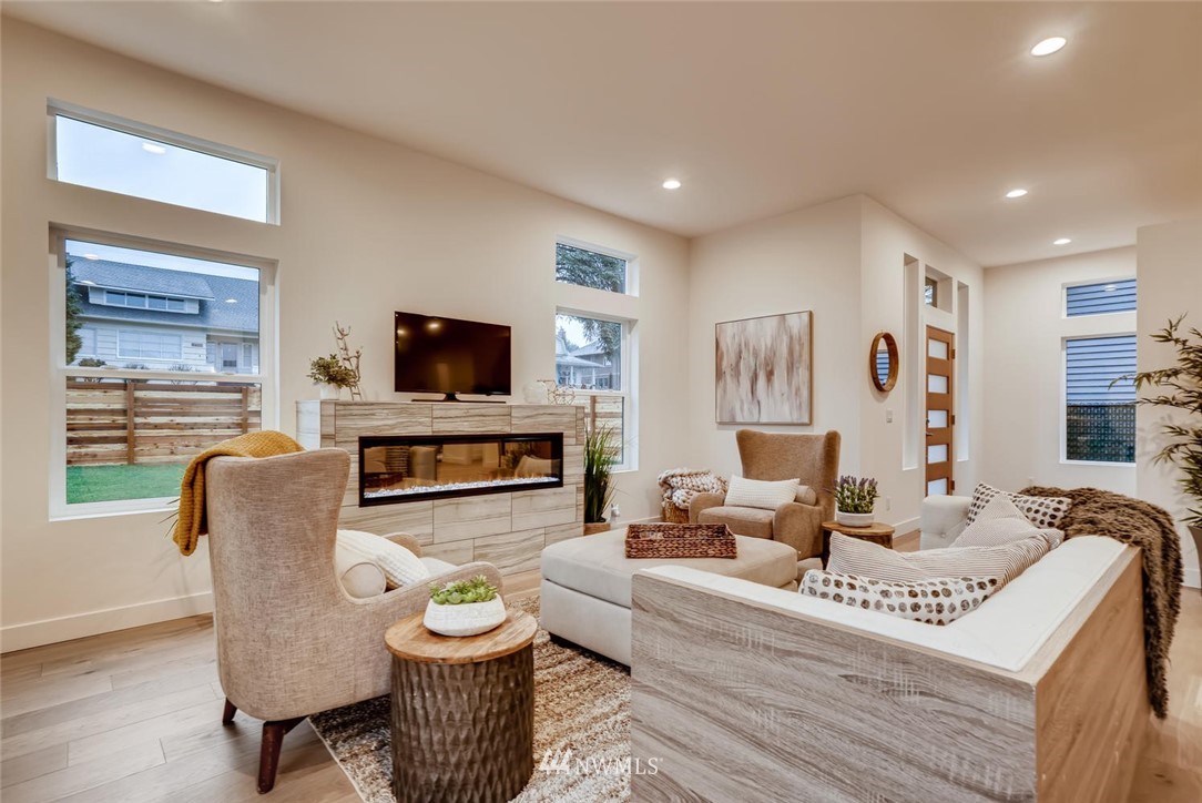 5603 42nd Avenue Southwest Seattle, WA 98136 - Photo 7 of 40 a living room with furniture a flat screen tv and a fireplace