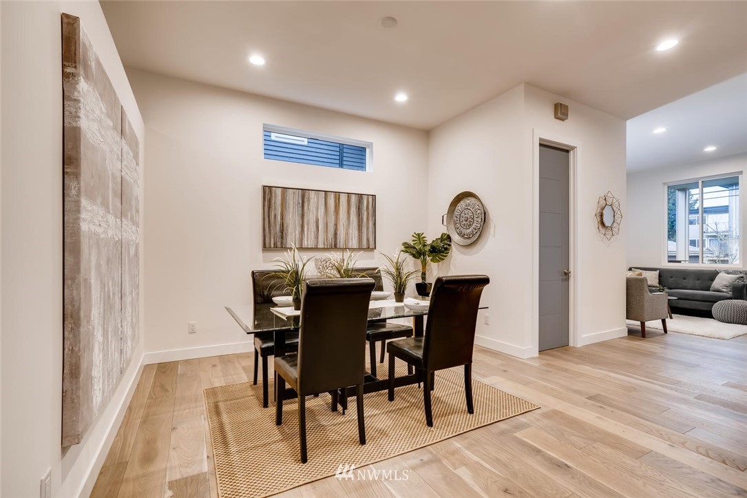 5603 42nd Avenue Southwest Seattle, WA 98136 - Photo 10 of 40 a view of a dining room with furniture and wooden floor