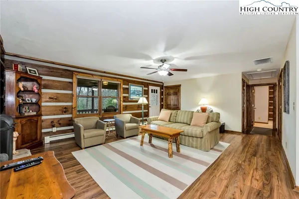 a living room with furniture and wooden floor