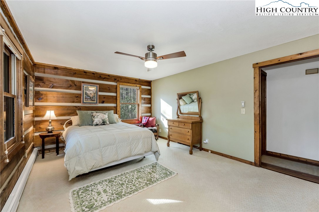 214 Deer Ridge Road Crumpler, NC 28617 - Photo 19 of 44 a bedroom with a bed and wooden floor