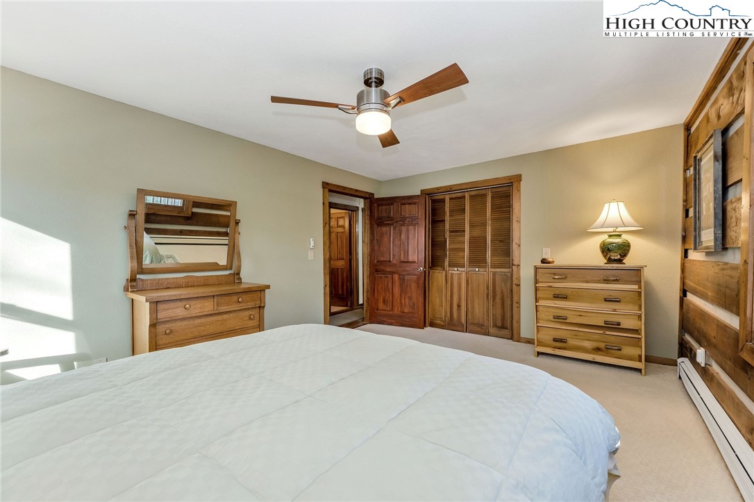 214 Deer Ridge Road Crumpler, NC 28617 - Photo 20 of 44 a bedroom with a bed and wooden floor