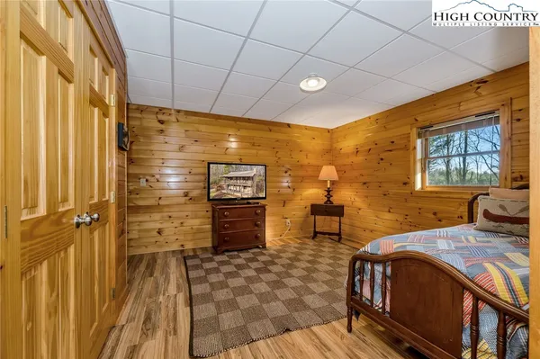 a spacious bedroom with a bed and a dresser