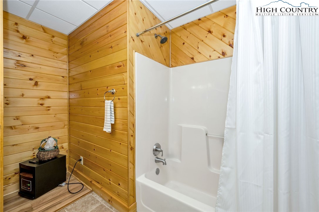 214 Deer Ridge Road Crumpler, NC 28617 - Photo 33 of 44 a bathroom with a bathtub and shower