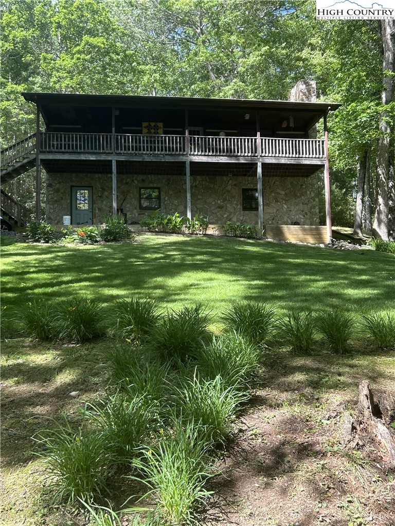 214 Deer Ridge Road Crumpler, NC 28617 - Photo 35 of 44 a front view of a house with a garden