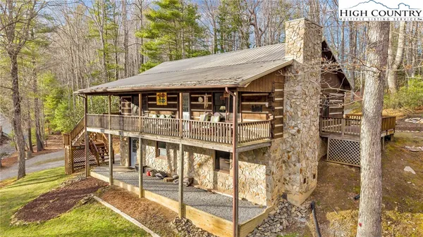 a view of a house with backyard and deck