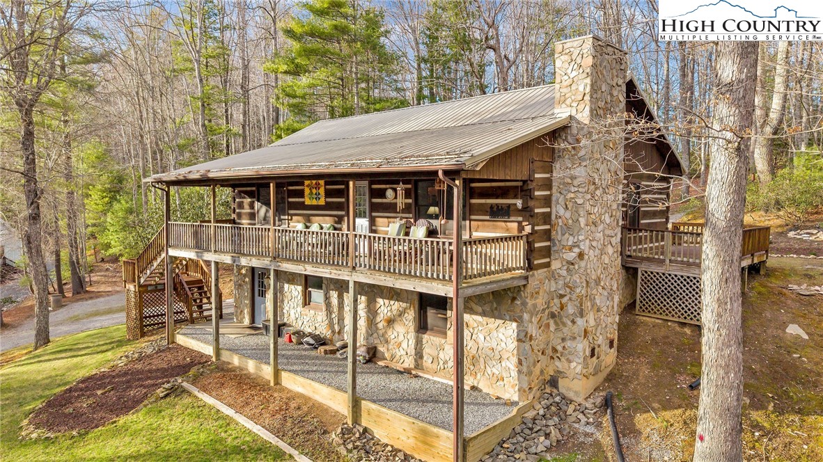214 Deer Ridge Road Crumpler, NC 28617 - Photo 42 of 44 a view of a house with backyard and deck