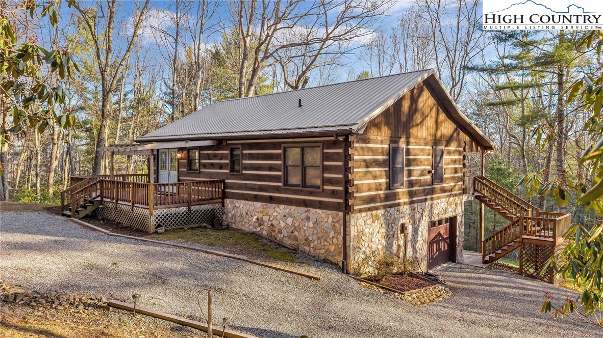 214 Deer Ridge Road Crumpler, NC 28617 - Photo 5 of 44 a view of a house with a small yard and wooden fence