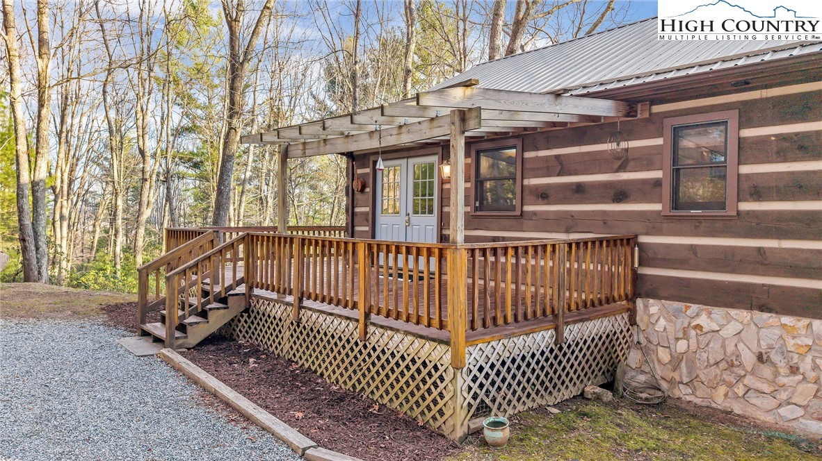 214 Deer Ridge Road Crumpler, NC 28617 - Photo 6 of 44 a view of a brick house with large windows and a small yard