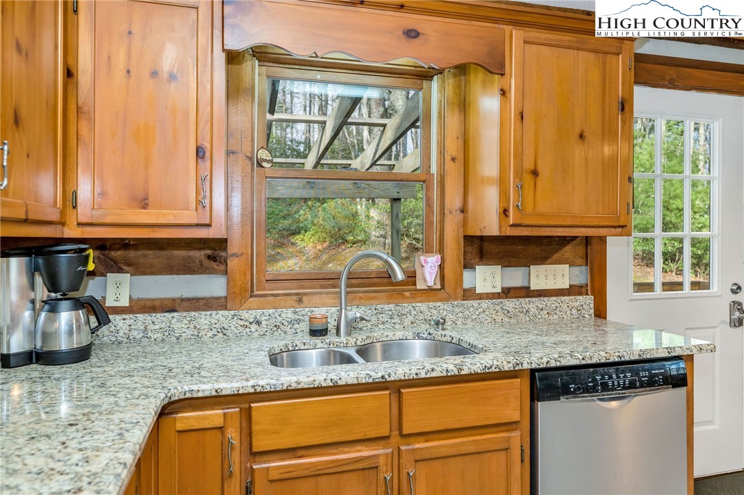 214 Deer Ridge Road Crumpler, NC 28617 - Photo 8 of 44 a kitchen with granite countertop a sink and a window