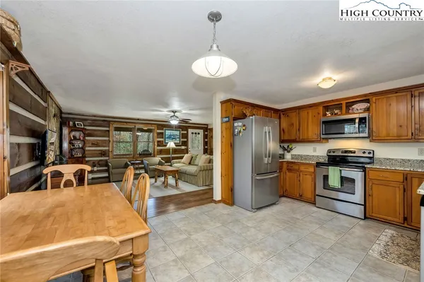 a kitchen with stainless steel appliances granite countertop a stove refrigerator and cabinets