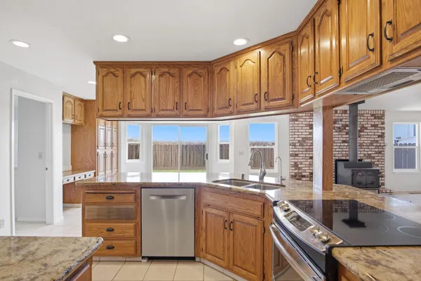 a kitchen with stainless steel appliances granite countertop a sink and cabinets
