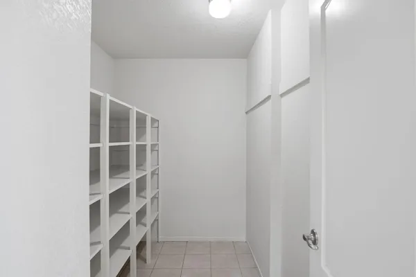 a bathroom with a granite countertop sink a toilet and a mirror